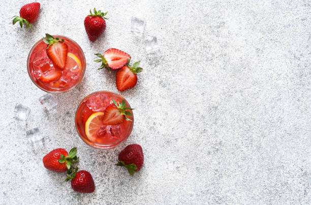 Strawberry lemonade with ice and mint, top view. Cold drink with strawberries. stock photo