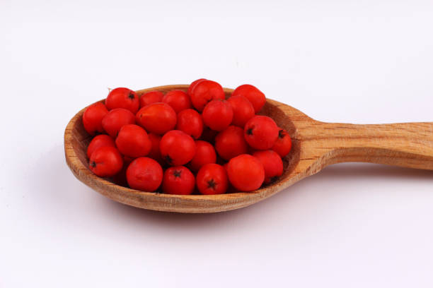 istock Bunch of red rowan in a wooden spoon isolate 1317915978