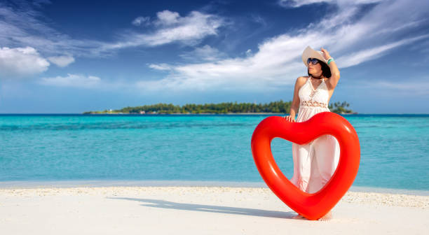 istock elegant lady with a heart-shaped float in Maldives 1317916346