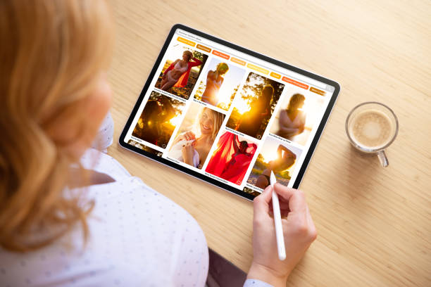 istock Woman browsing photos online on tablet computer 1317927790