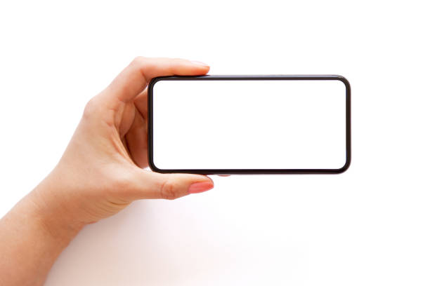 istock Mobile phone with empty white screen held horizontally in hand, isolated on white background 1317927837