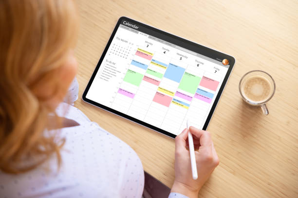 istock Woman using calendar app on tablet computer for appointment and task management 1317927925