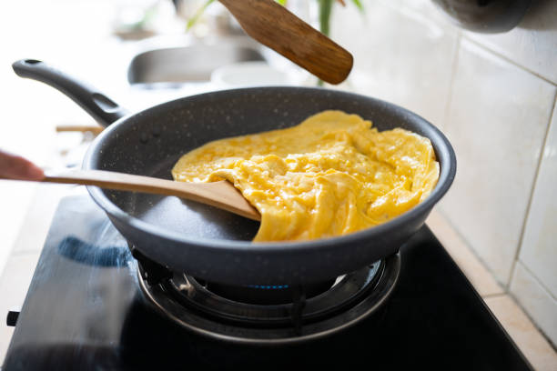 istock fried omelet in hot pan on strove 1317928121
