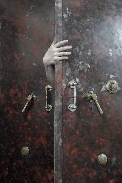 braccia spaventose - lock door horror gate foto e immagini stock