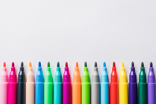 Colored markers on a sheet of white paper. Selective focus. Backgrounds and textures.