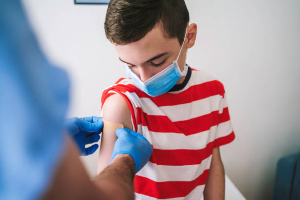 Patient Getting Vaccinated against COVID-19. Child, teenage boy vaccination. Coronavirus epidemic. Copy space. stock photo