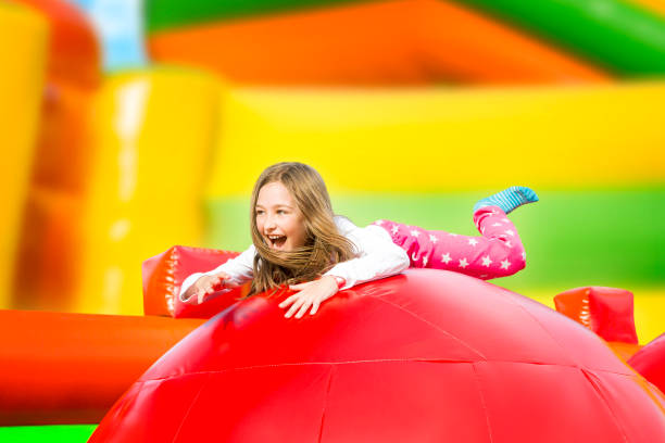 happy girl on the playground inflate castle - inflatable child jumping leisure games imagens e fotografias de stock