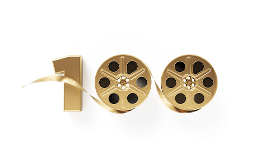 Gold colored film reel forming 100 on white background. Horizontal composition with copy space. Directly above. Top 100 films concept.