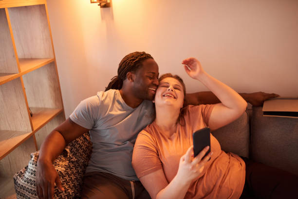 istock Couple bonding to each other and laughing while making selfie at the smartphone 1317943627