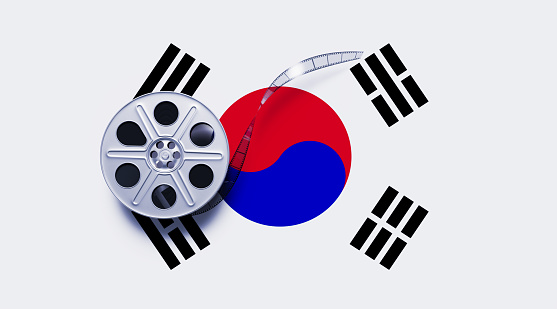Film reel sitting over South Korean flag. South Korean cinema industry concept. Horizontal composition with copy space. Directly above.