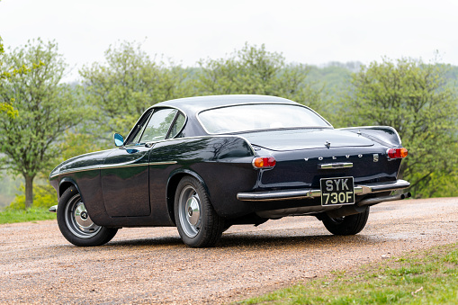 Ivinghoe, Buckinghamshire - May 6, 2021: A dark blue Volvo 1800S from 1967 parked up near Ivinghoe Beacon, Buckinghamshire.