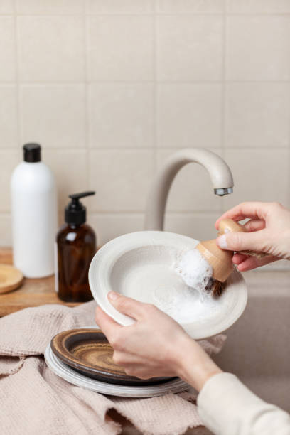 Woman washing dishes in kitchen