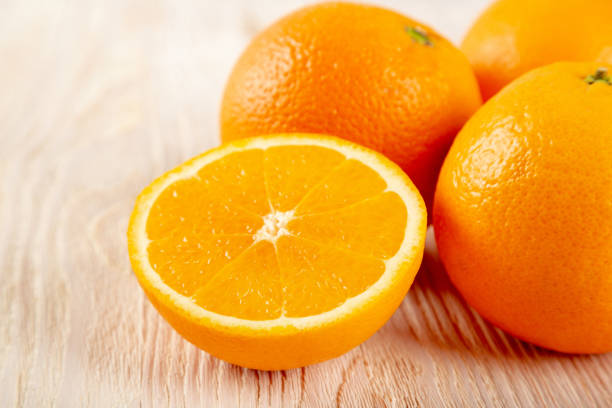 istock Fresh oranges on a wooden background 1317945714