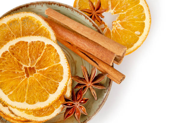istock Dried oranges and cinnamon in a plate on a white background 1317945763