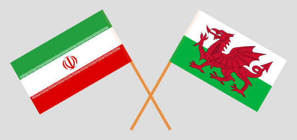 skrzyżowane flagi iranu i walii. oficjalne kolory. prawidłowa proporcja - iran wales stock illustrations