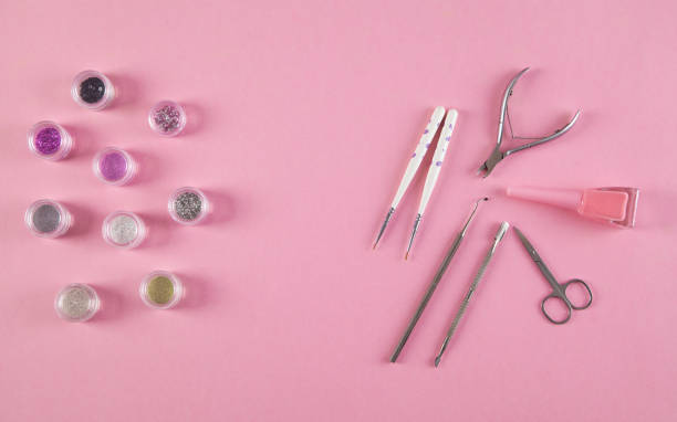 Manicure accessories on an isolated pink background.