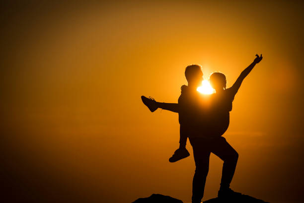 istock Silhouette of Couple Having Fun Outdoors During Sunset 1317948201