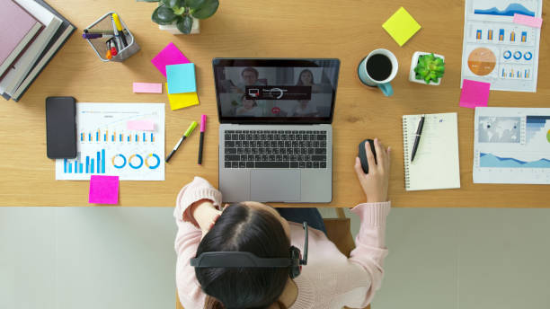 istock Overhead top view young asian woman employee work from home using computer notebook videocall meeting conference angry annoy with low poor unreliable internet wifi connection problem issue outage. 1317949336