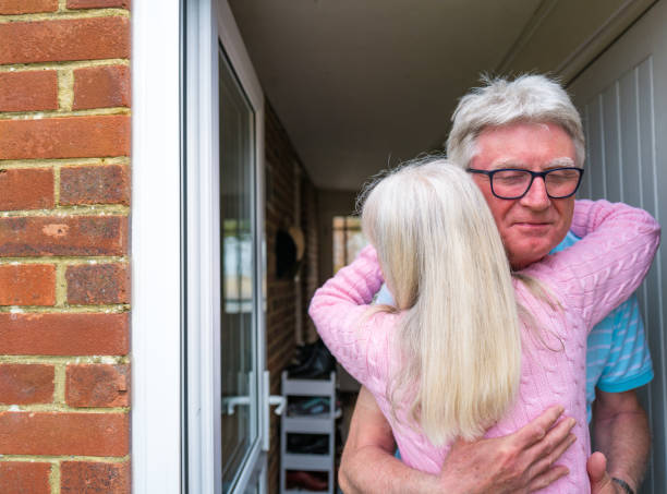 istock Seniors hugging again for the first time 1317949506