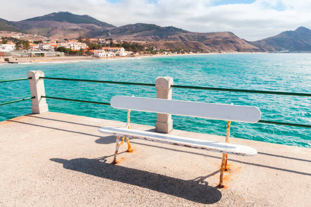 istock Vila Baleira landscape with white bench on pier 1317950597