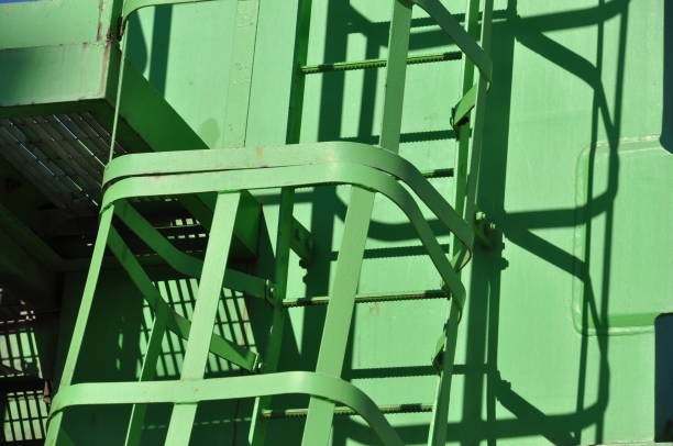 Steel ladder in front of white metal door