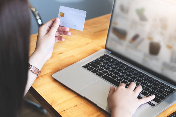 istock Online payment with Young Women hands holding  credit card and using computer  for online shopping 1317951979