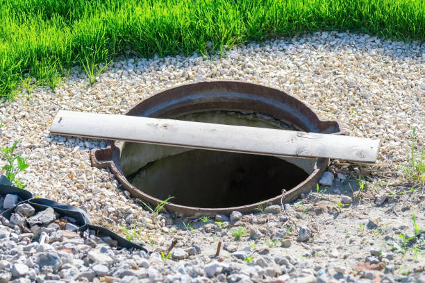 istock The sewer manhole without a lid is covered with one thin board. 1317952653