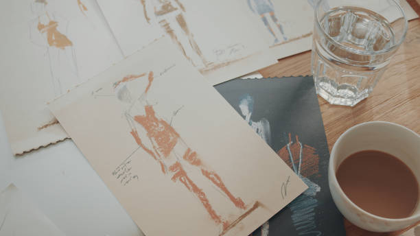 istock Fashion sketches in artist's studio. Table close up 1317952804