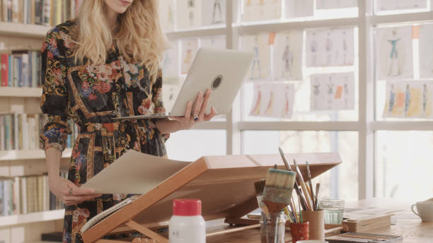 istock Female fashion designer at work. Creating new collection, picking projects 1317952827