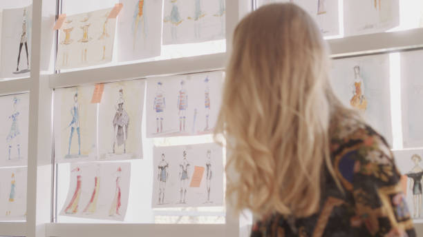 istock Female fashion designer at work. Sitting on desk. Creating new collection, picking projects 1317952880
