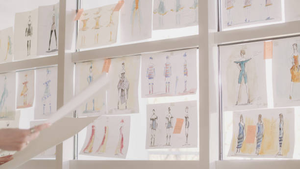 istock Female fashion designer at work. Creating new collection, picking projects 1317952888