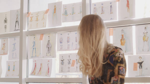 istock Female fashion designer at work. Creating new collection, picking projects 1317952889