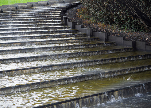 Water flows down the stone steps of the stairs.