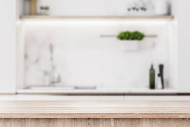 istock Modern light wooden tabletop with copyspace for your text at blurry kitchen utensils and dishes on light wall background. 3D rendering, mock up 1317955392