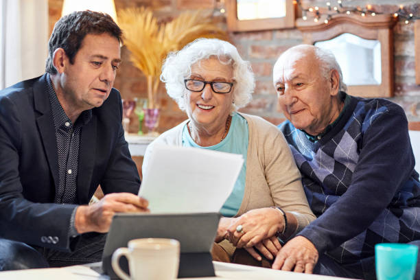 istock Elderly couple with financial advisor at home 1317955607
