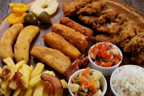 istock Cuban filet. Made with breaded Steak, cheese, breaded ham and banana, Vinaigrette, white rice, pineapple and Fig. Typical Brazilian dish. Tropical cuisine. 1317955620