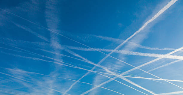 istock Image of several contrails caused by airplanes in a blue sky 1317956807