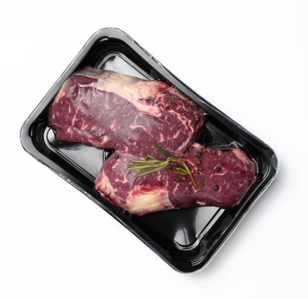 istock two raw beef steaks in a plastic container with spices and vacuumized on a white background, packaging for long-term storage 1317957126