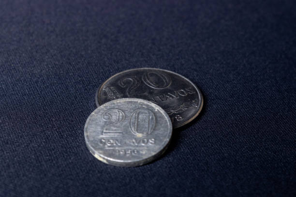 istock Two overlapping old twenty-cent coins dated 1956 and 1978 used in Brazil on a dark black background. 1317957143