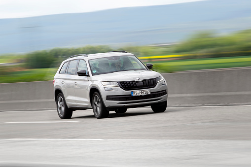 Weilbach, Germany - May 12, 2021: A male driver in a grey Skoda Kodiaq on a highway nearby Wiesbaden, Germany. The Skoda Kodiaq is a seven seat mid-size crossover SUV manufactured by the Czech automaker Skoda Auto. Skoda is a car manufacturer based in the Czech Republic and a wholly owned subsidiary of the Volkswagen Group.