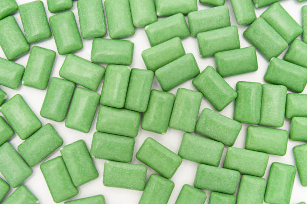 istock Green mint chewing gum tablets scattered randomly. Isolated on white background. Top view 1317959248
