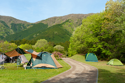 Tourist tent at the Bzerpinski cornice campsite in the morning, Caucasus mountains