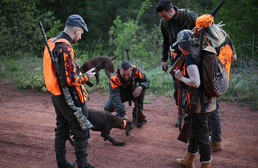 Group of Hunters with Their Dogs Going for Hunting Action