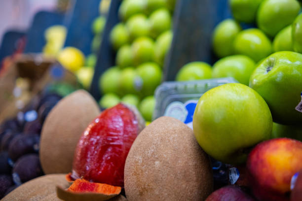 istock Colorful fruit stand with mamey, green apples, and more 1317961385
