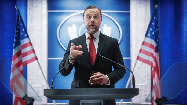 istock Charismatic Organization Representative Speaking at a Press Conference in USA Government Building. Press Office Representative Delivering a Speech at a Summit. Minister Speaking to Congress. 1317961649