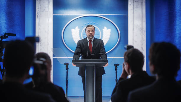 istock Charismatic Organization Representative Greeting Supporters at Conference in Government Building. Press Office Representative Delivering a Speech at a Summit. Minister Speaking to Congress. 1317961730