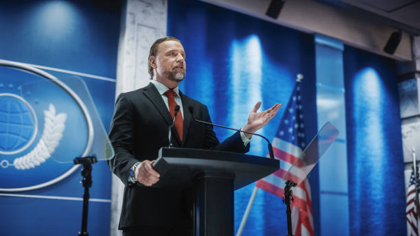 istock Charismatic Organization Representative Speaking at a Press Conference in USA Government Building. Press Office Representative Delivering a Speech at a Summit. Minister Speaking to Congress. 1317961732