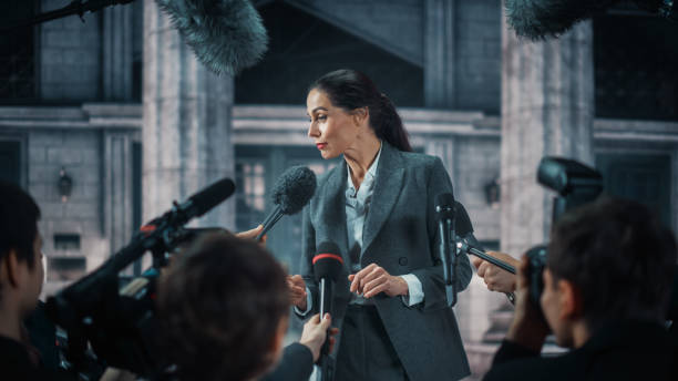 Organization Representative Answering Press Questions and Giving Interview Outside a Parliament, Court or Other Government Building. Press Officer or Businesswoman Crowded by News Journalists.