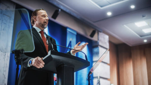 istock Charismatic Organization Representative Speaking at a Press Conference in USA Government Building. Press Office Representative Delivering a Speech at a Summit. Minister Speaking to Congress. 1317961816
