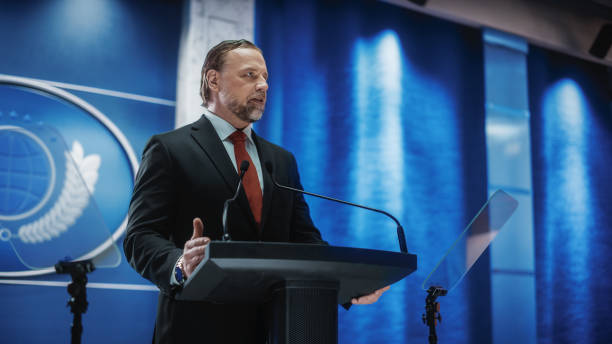 istock Charismatic Organization Representative Speaking at a Press Conference in USA Government Building. Press Office Representative Delivering a Speech at a Summit. Minister Speaking to Congress. 1317961843